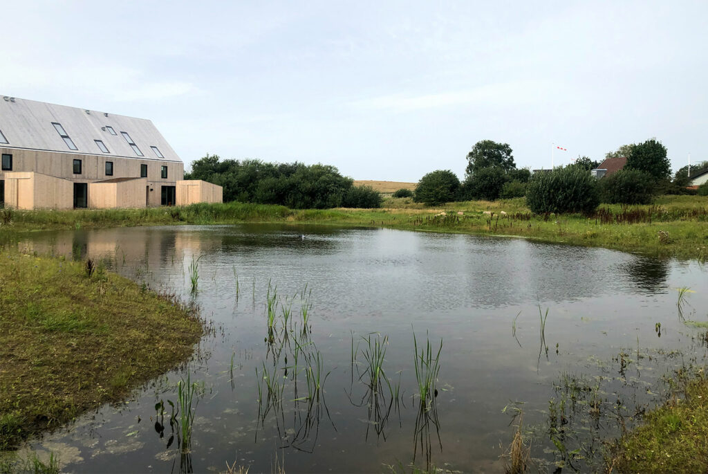 Ranwater harvesting pond next to a building.