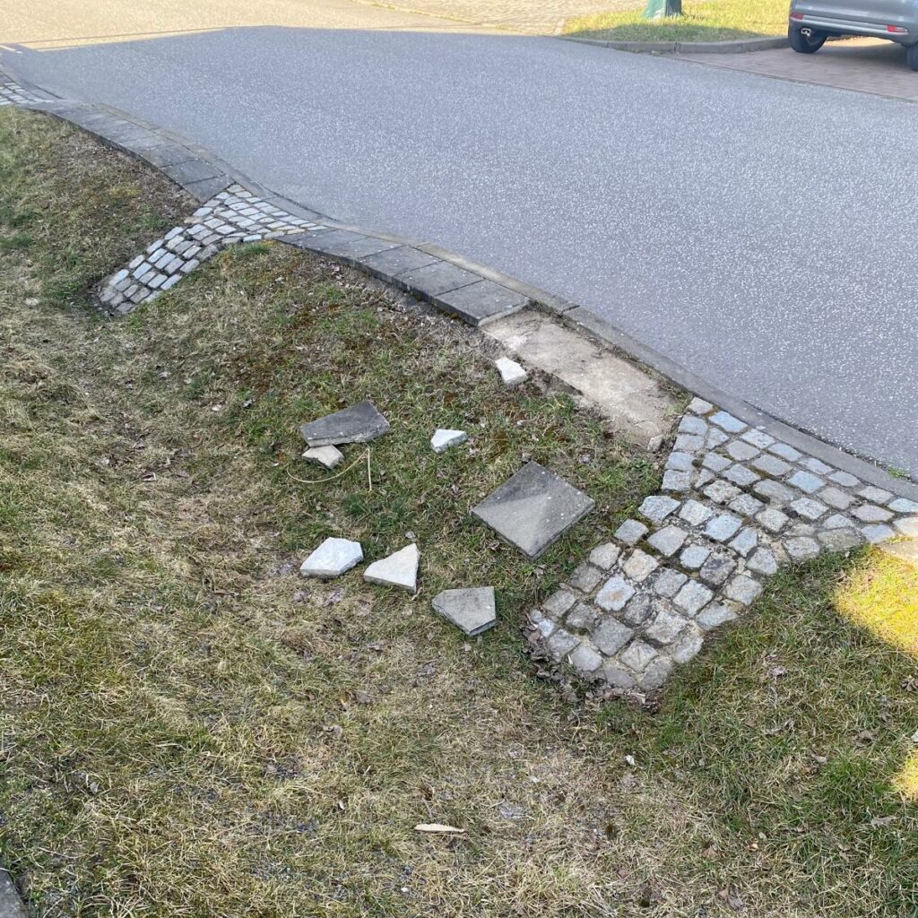 Some damaged tiles used in a swale next to a road.